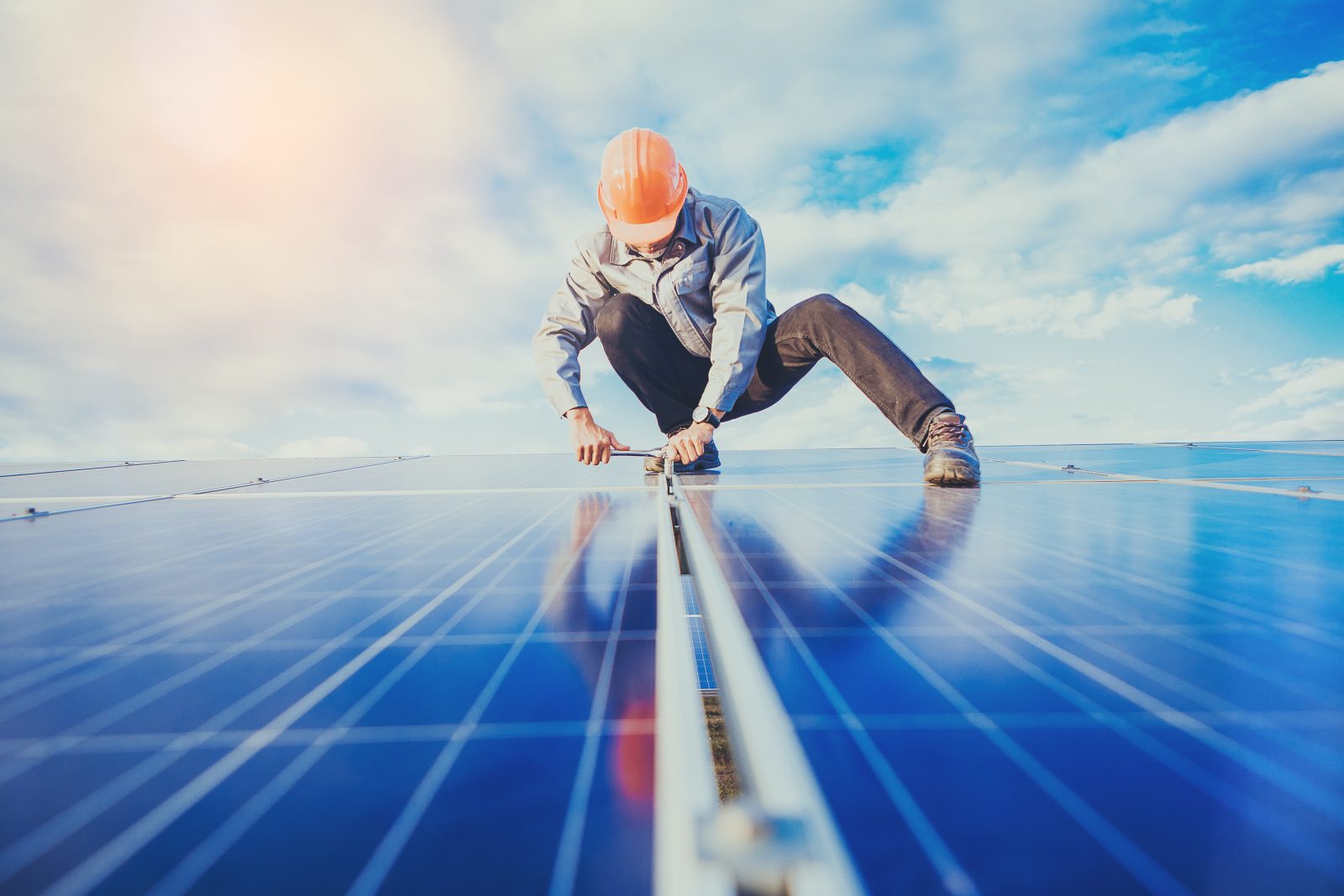 Electrical and instrument technician use wrench to maintenance electric system at solar panel field